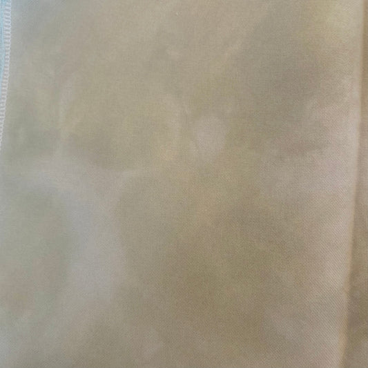 32 count Cobblestone linen from Atomic Ranch Fabrics. A close-up image of a hand dyed, variegated, light cream colored 32 count linen fabric.